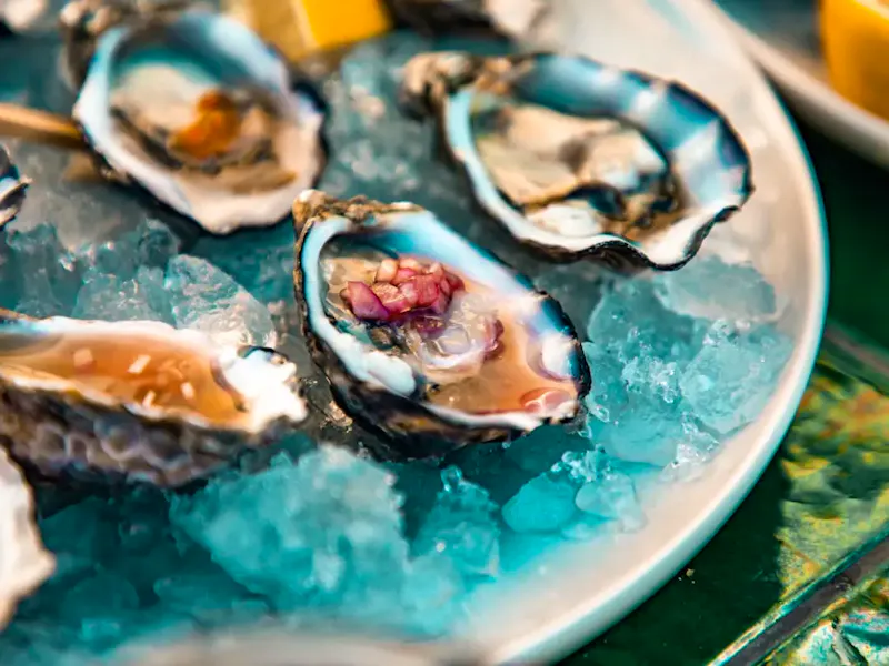 Image of Le Bistrot Marceau I Brunch & Dîner Jazzy a plate of oysters on ice with lemon wedges | Photo by Anima Visual, on https://unsplash.com/@animavisual?utm_source=centralapp&utm_medium=referral