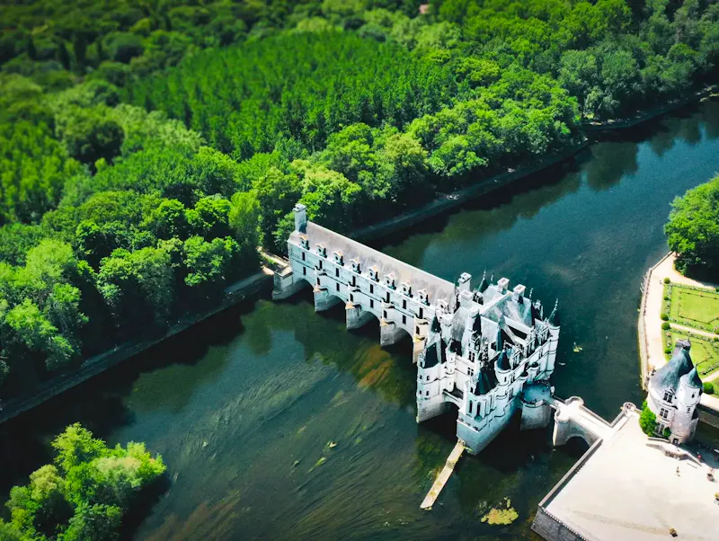 Stunning aerial view of Château de Chenonceau surrounded by lush greenery in Centre-Val de Loire, France. | Photo by Ferdinand F Eman, on https://www.pexels.com/@ferdinand-f-eman-285178834?utm_source=CentralApp&utm_medium=referral