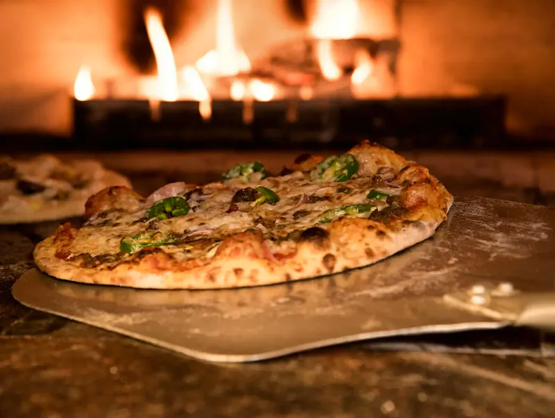 Appetizing gourmet pizza cooked in a wood-fired oven, showcasing artisanal toppings. | Photo by Eneida Nieves, on https://www.pexels.com/@fariphotography?utm_source=centralapp&utm_medium=referral