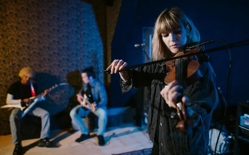 Young musicians practicing together indoors with violin and guitars, focused on performance. | Photo by RDNE Stock project, on https://www.pexels.com/@rdne?utm_source=centralapp&utm_medium=referral