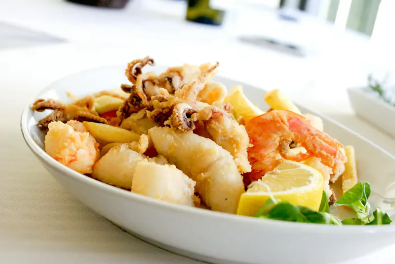 Deep Fried Shrimp and Squid With Slice of Lemon on Ceramic Plate | Photo by Alex Favali, on https://www.pexels.com/@puntoitalia?utm_source=centralapp&utm_medium=referral