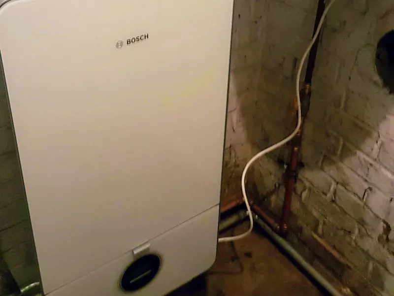 At this client's home, we were called in to address an outdated heating system: an old boiler combined with an old Vaillant water heater