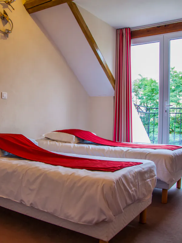 Chambre confortable pour cinq personnes, équipée de cinq lits simples, avec salle de bain et toilettes privatives. Petit-déjeuner inclus.