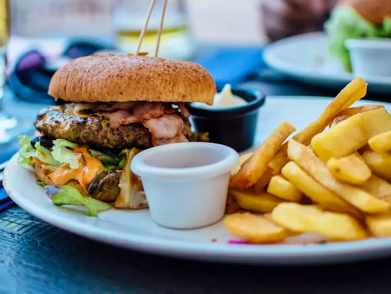 Image of Le Court Tournant selective focus photography of burger patty, mayonnaise, and French fries served on platter | Photo by Robin Stickel, on https://unsplash.com/@robinstickel?utm_source=CentralApp&utm_medium=referral