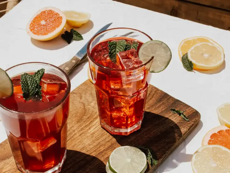 two clear drinking glasses with filled red liquid | Photo de Katherine Sousa, sur https://unsplash.com/@ksousaphotography?utm_source=CentralApp&utm_medium=referral