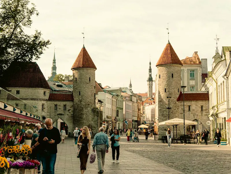 A group of people walking down a street next to tall buildings | Photo de Jan Ledermann, sur https://unsplash.com/@jan_ledermann?utm_source=CentralApp&utm_medium=referral