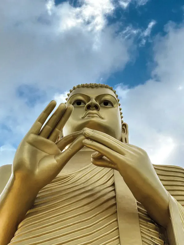 Image of Nuad Sabai Massages Majestic golden Buddha statue with blue sky backdrop in Sri Lanka. | Photo by Marina Zvada, on https://www.pexels.com/@marina-zvada-844583049?utm_source=centralapp&utm_medium=referral
